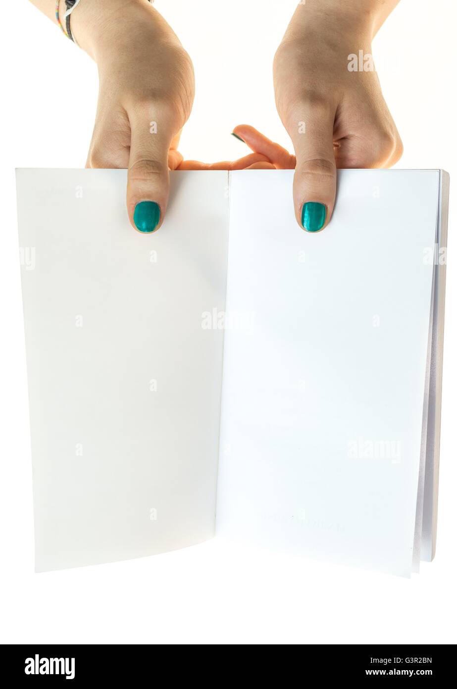 hands with green nails polish holding a book with blank pages, isolated on white background Stock Photo