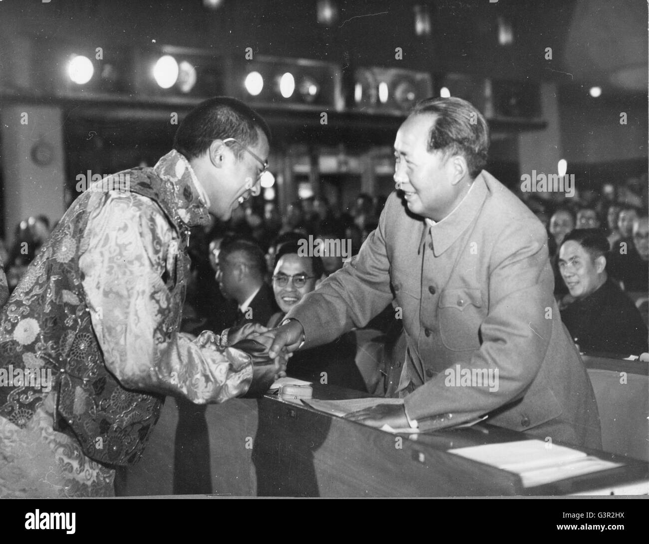 Scene at the First Session of the First National People's Congress. As Mao Tse-tung was announced Chairman of the People's Republic of China, the Dalai Lama, deputy of the Tibetan Region, greets him. Stock Photo