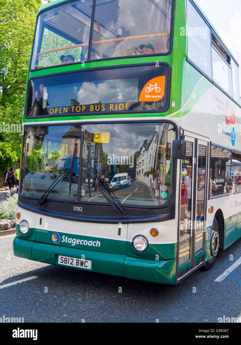 An open topped double decker bus  taking tourists on a tour around the English Lake District Stock Photo