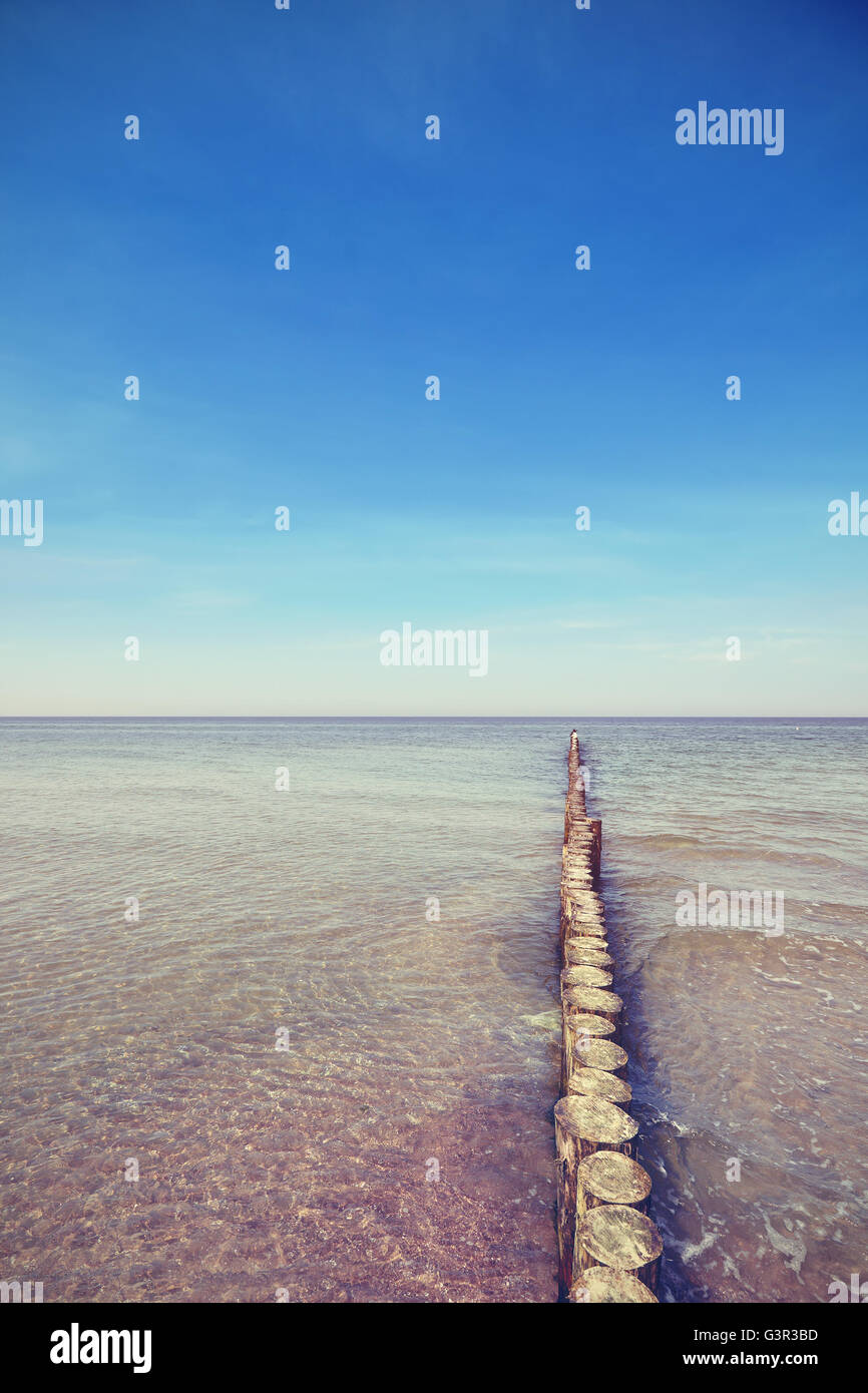 Vintage toned old wooden breakwater. Stock Photo