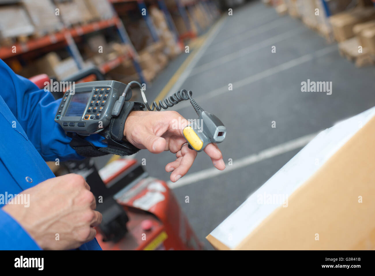 Scanning parcel in warehouse with finger scanner Stock Photo Alamy