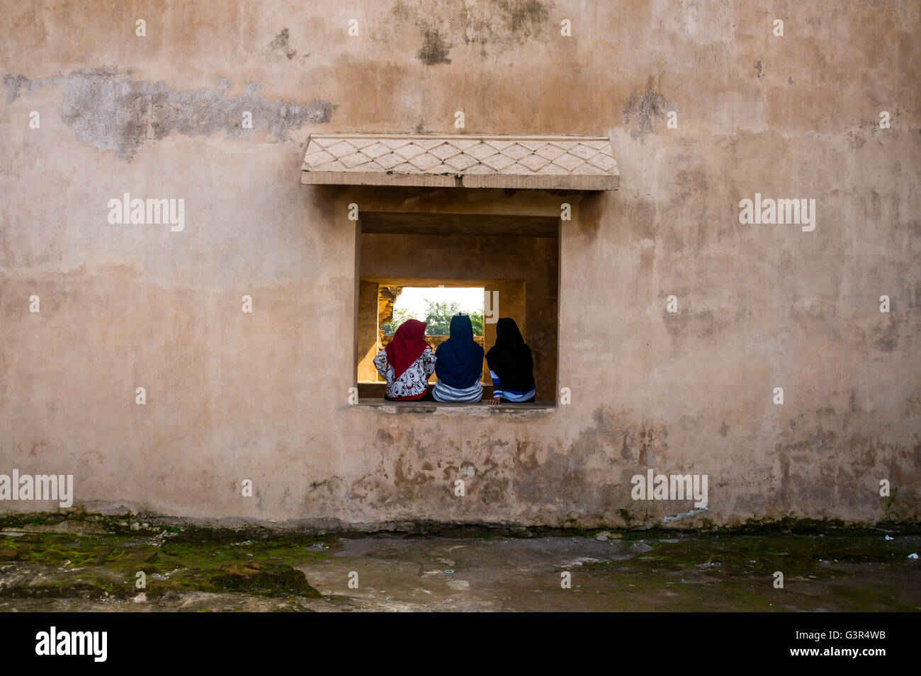 Three Moeslim Women Sitting Facing Back Stock Photo