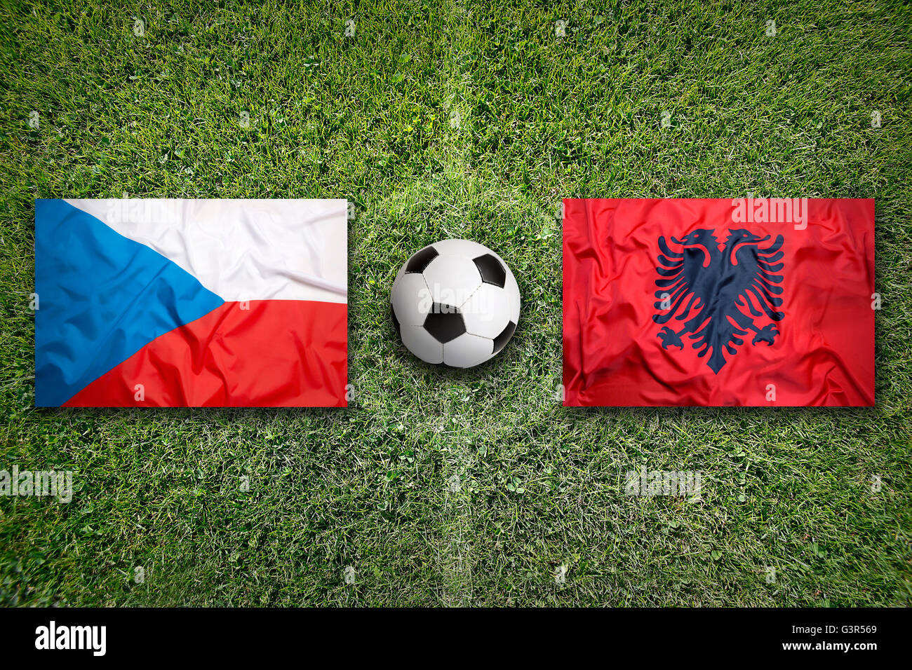 Czech Republic vs. Albania flags on green soccer field Stock Photo