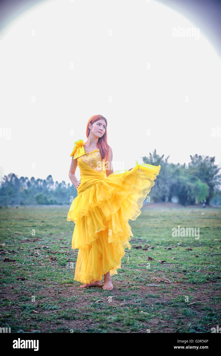 Beautiful woman in yellow dress hi-res stock photography and images - Alamy