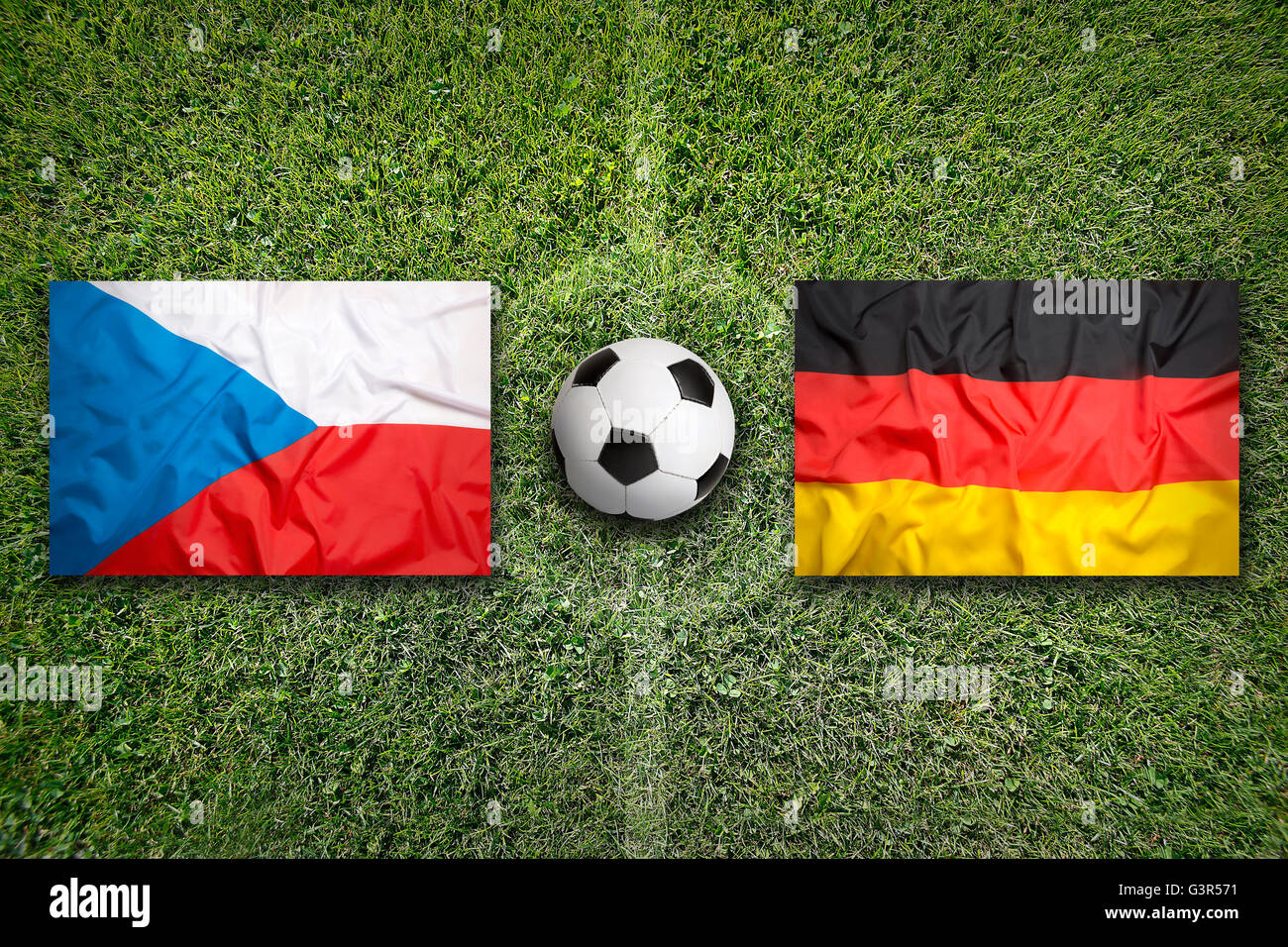 Czech Republic vs. Germany flags on green soccer field Stock Photo