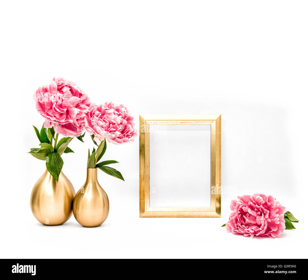 Golden picture frame and pink flowers. Minimal style decoration with space for your image text work Stock Photo