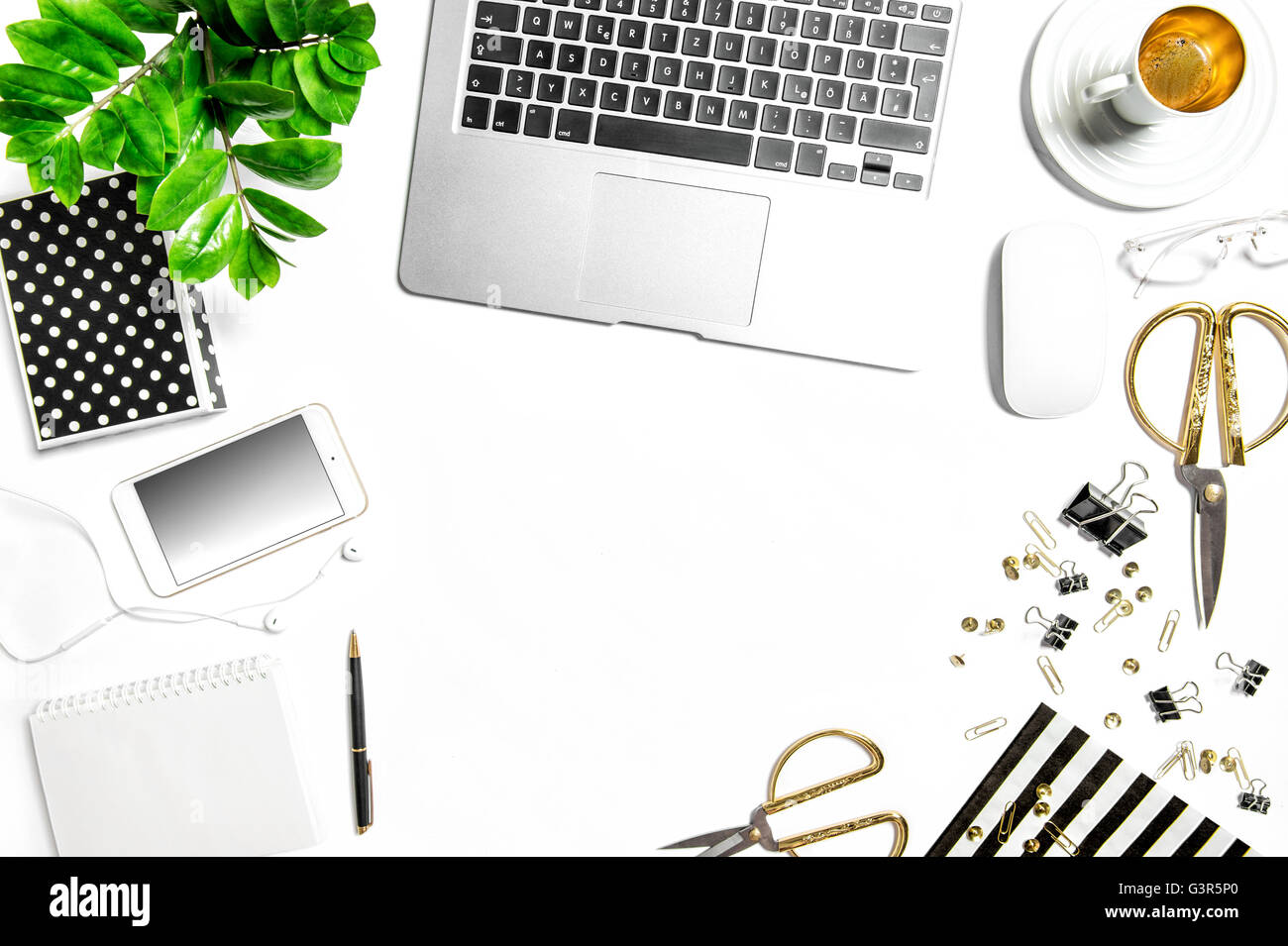 Workplace with notebook, digital phone, office supplies, diary, coffee, green plant. Creative working desk. Hero header Stock Photo