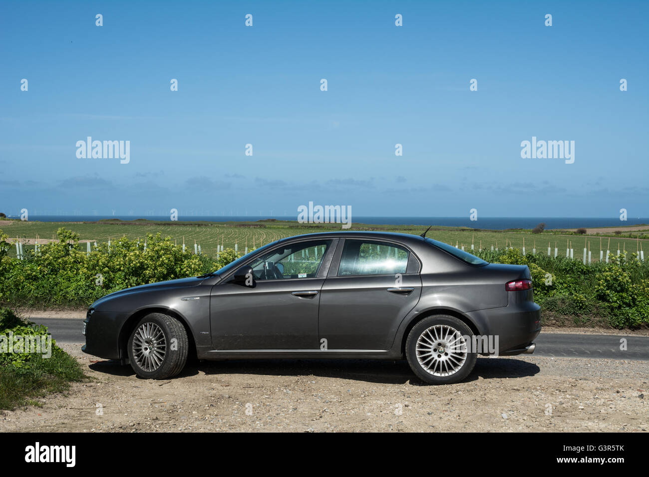 An Alfa Romeo 159 parked on the side of the road in dark grey Stock Photo -  Alamy
