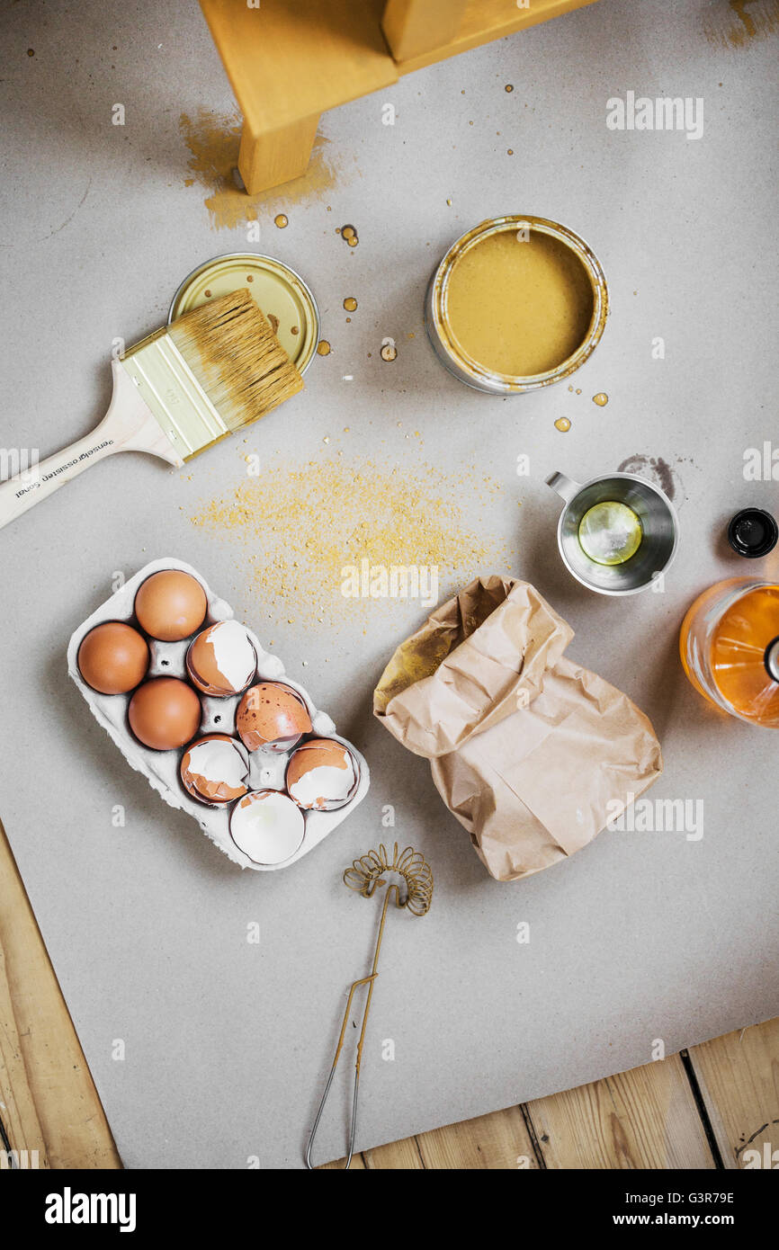 Sweden, Directly above view of paintbrush, wire whisk and cracked eggs Stock Photo