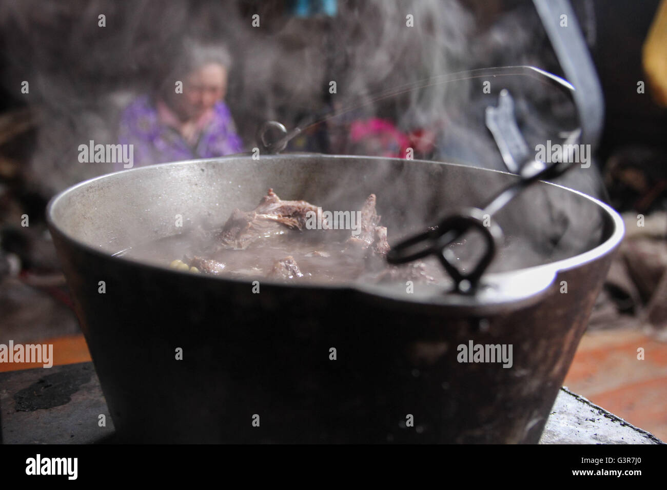 Cooking venison soup, inside the chum-traditional dwellings of Nenets reindeer breeders. Stock Photo