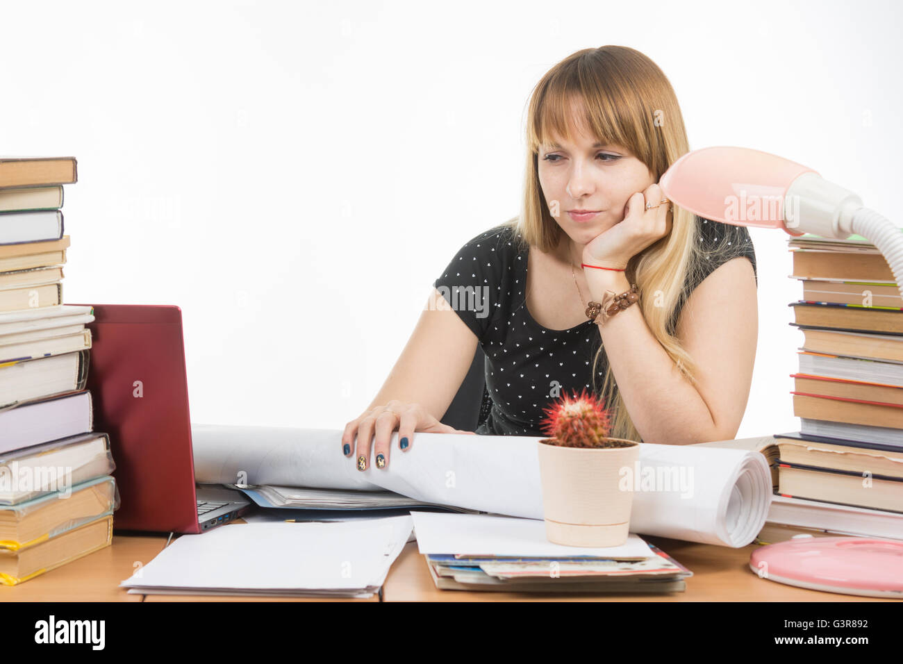 Student with contempt and weariness looking at laptop monitor Stock Photo