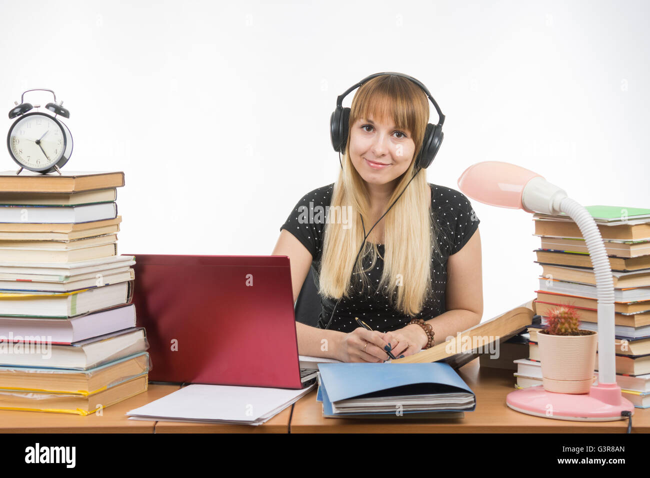 Student with headphones ready to pass the diploma project looked into the frame Stock Photo