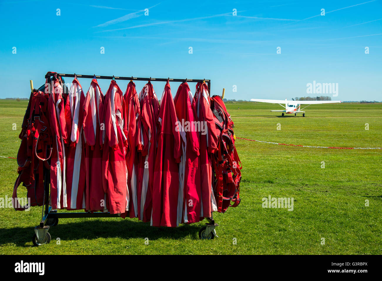 parachutist jumpsuits at rack at texel parachute centre holland Stock Photo