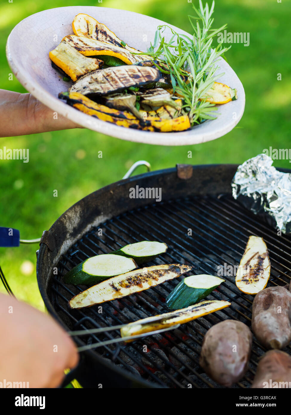 Sweden, Grilled vegetables on plate and grill Stock Photo