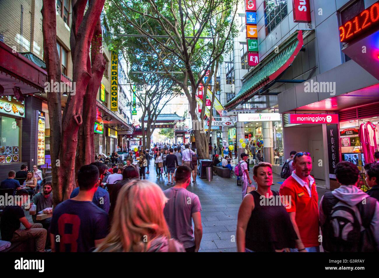 A street scene in the Chinese quarter of Sydney, Australia with many shoppers buying and eating. Stock Photo
