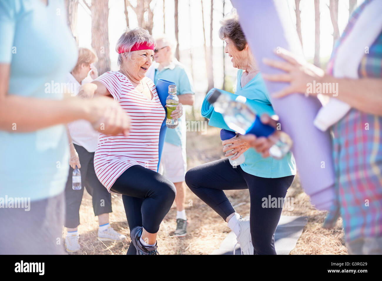 Senior women practicing yoga tree pose in park Stock Photo - Alamy
