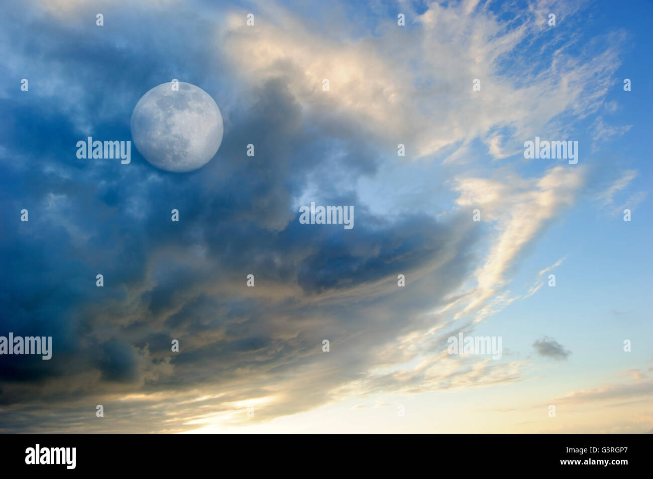 Moon clouds skies is a vibrant surreal fantasy like cloudscape with the ethereal heavenly full moon rising among the clouds. Stock Photo