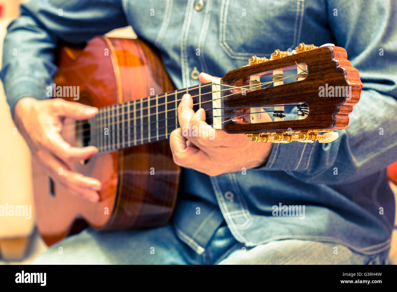 Vintage guitar player in artistic performance Stock Photo