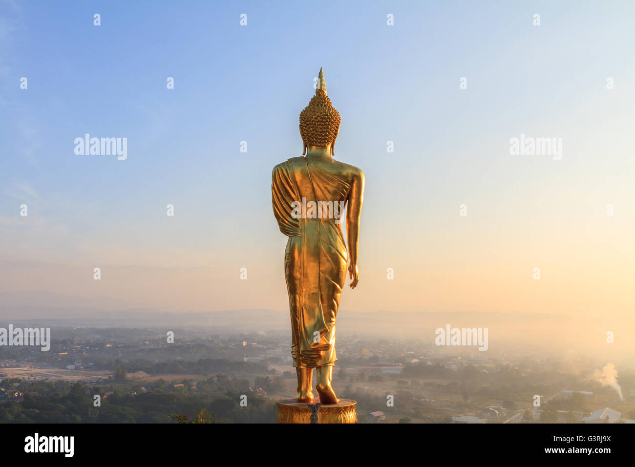 behind of golden buddha statue in sunrise time Stock Photo