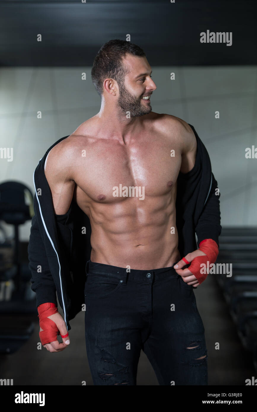 Portrait Of A Physically Fit Man Showing His Well Trained Body In Gym Stock Photo Alamy