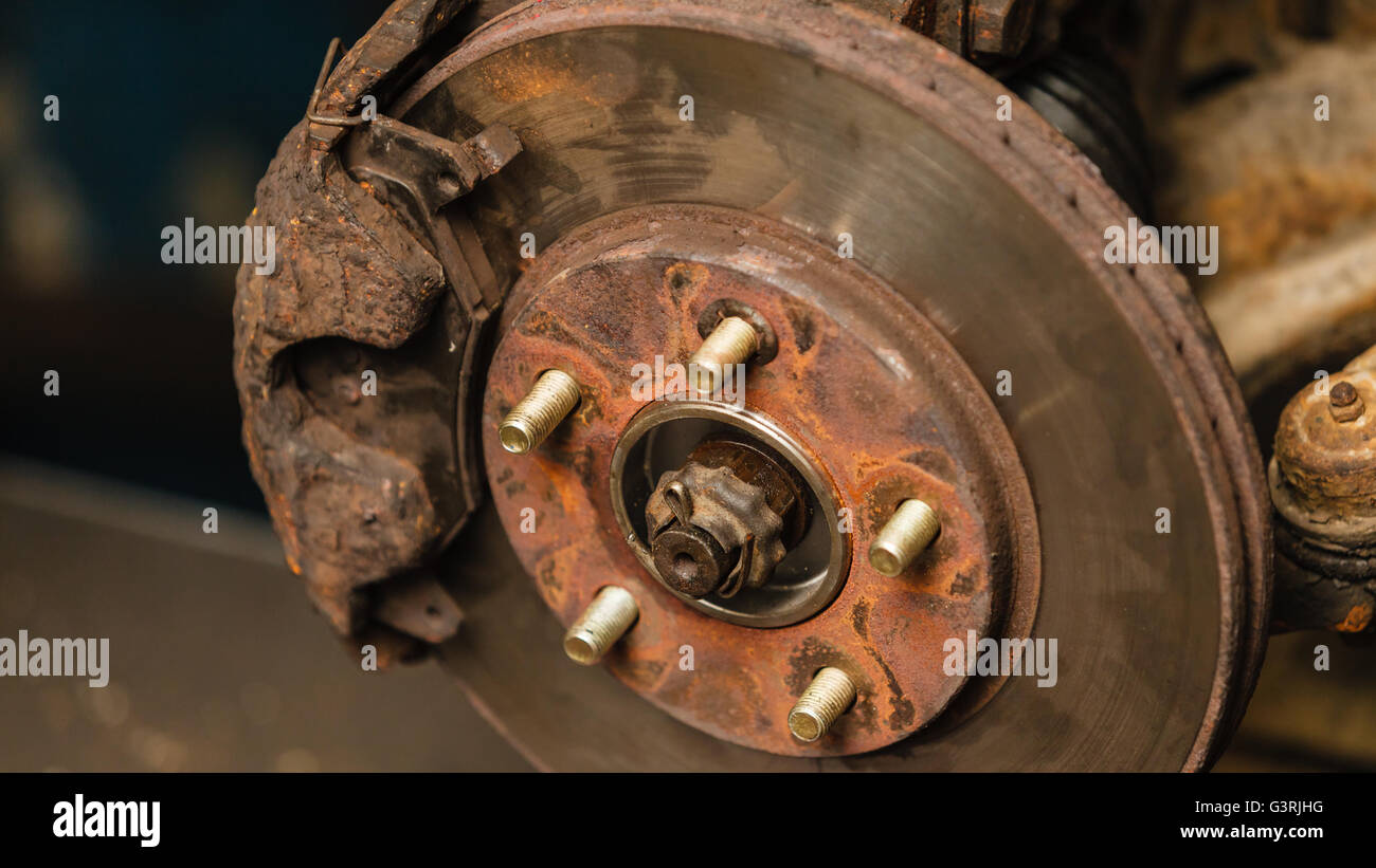 Automotive mechanical industry concept. Disc brakes in workshop. Disassembled car parts in garage. Stock Photo
