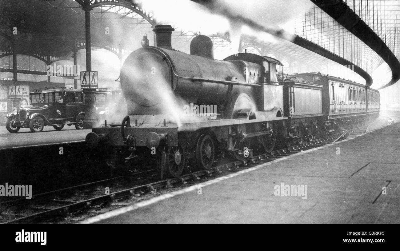 A LNWR Precursor 4-4-0 arrives at Euston with an outer suburban service possibly from Bletchley or Rugby. Stock Photo