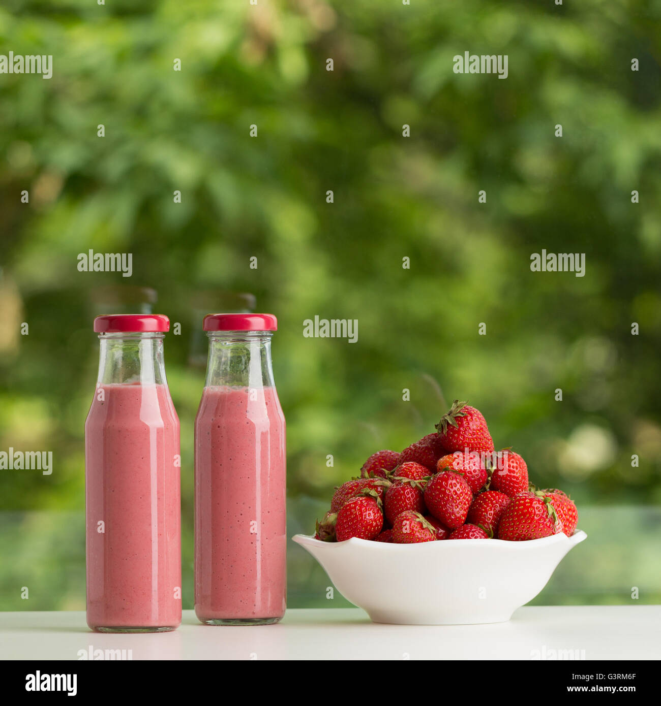 Download Strawberry Smoothie In Glass Bottle On Green Background Selective Stock Photo Alamy Yellowimages Mockups
