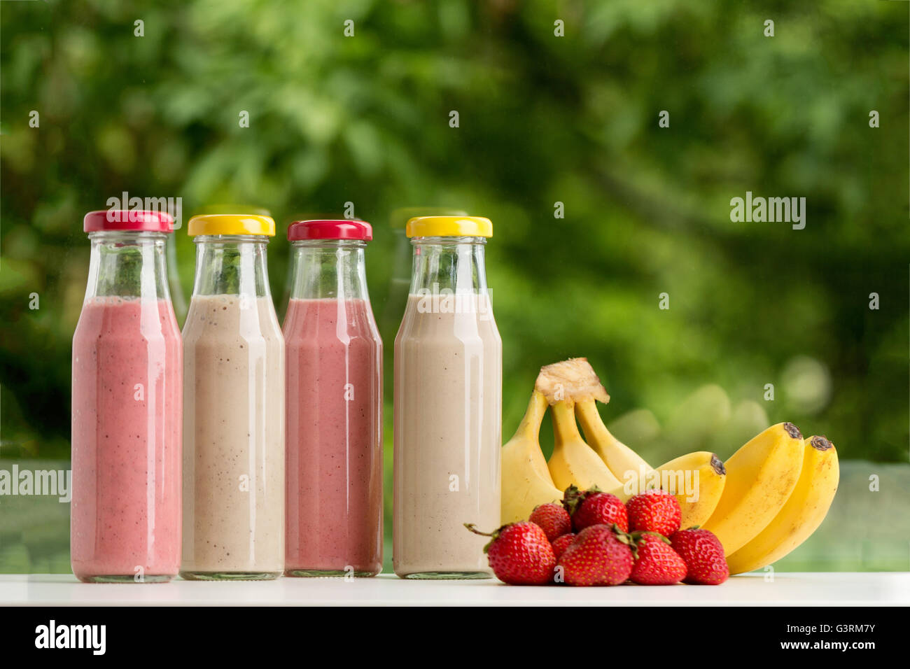 Download Strawberry And Banana Smoothie In Glass Bottle On Green Background Stock Photo Alamy Yellowimages Mockups