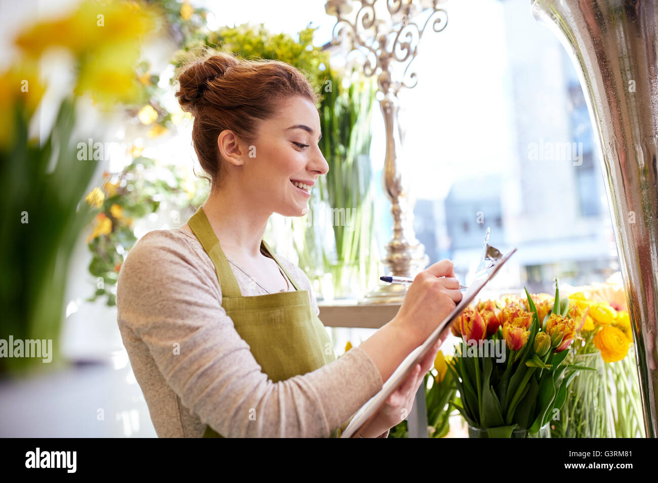 florist woman with clipboard at flower shop Stock Photo - Alamy