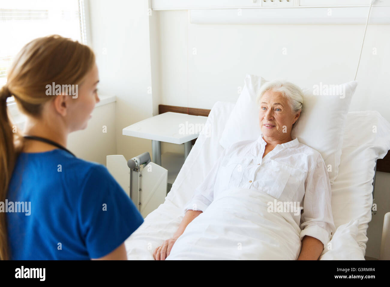 doctor or nurse visiting senior woman at hospital Stock Photo - Alamy