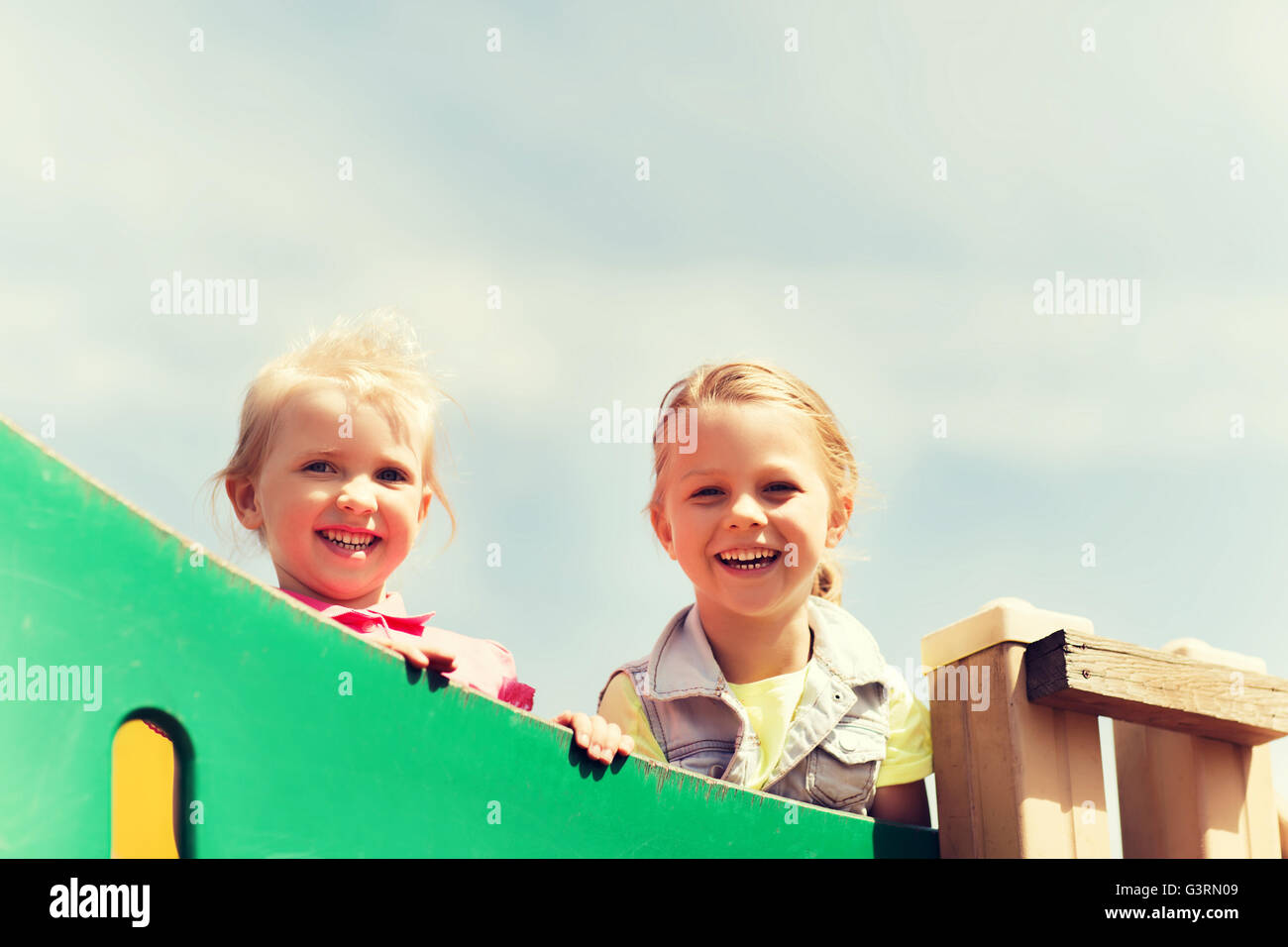 happy little girls on children playground Stock Photo - Alamy