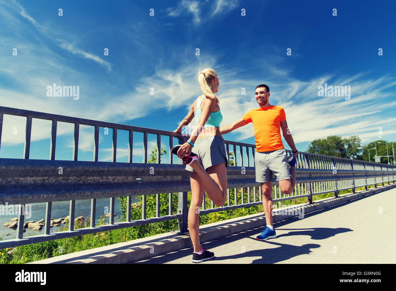 Sportive woman stretching leg fence hi-res stock photography and images ...