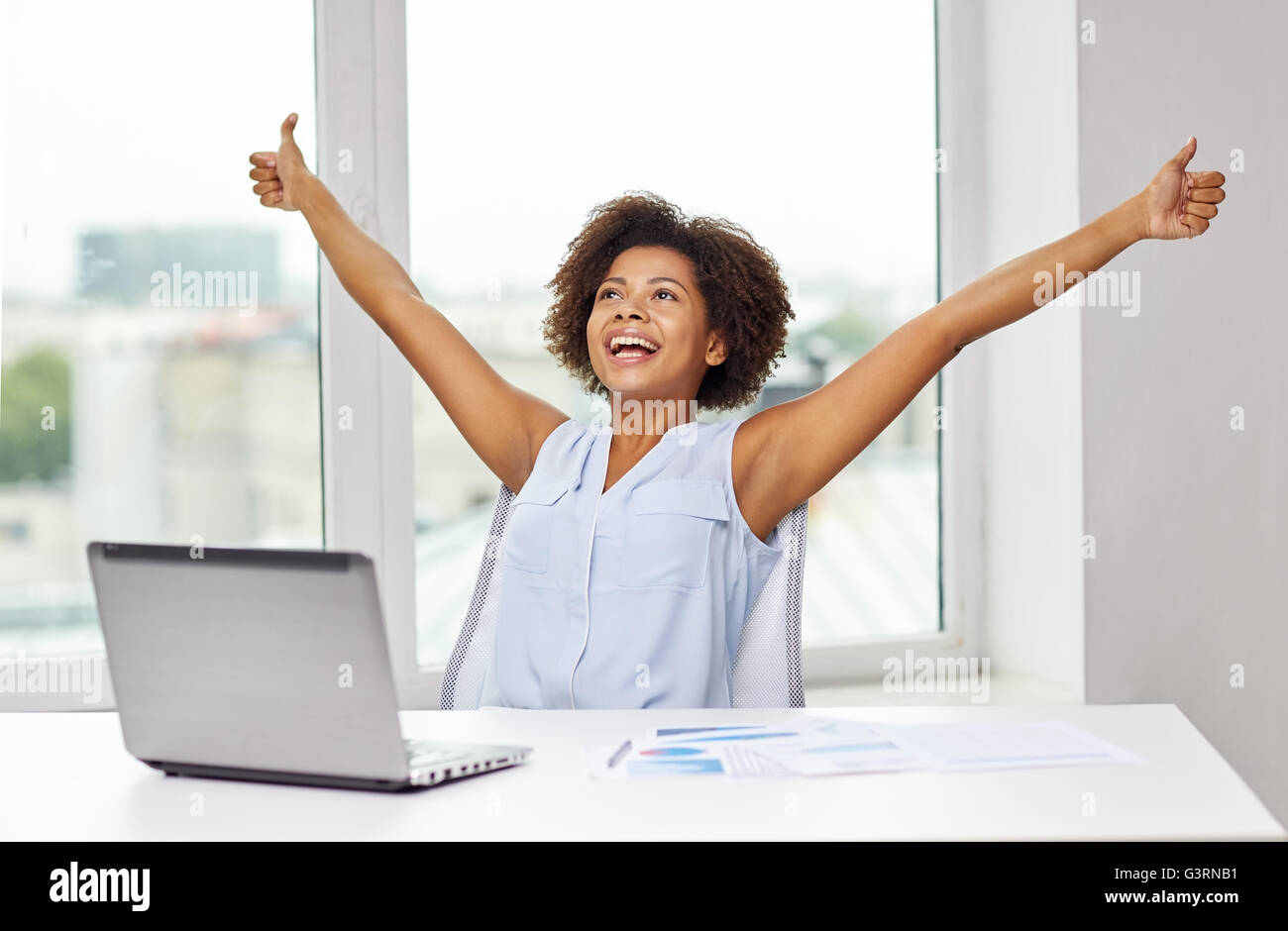 happy african woman with laptop at office Stock Photo - Alamy