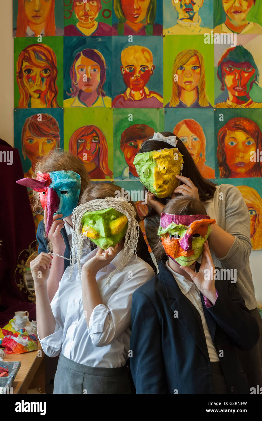 School children wearing face masks they created in the art department. England. UK Stock Photo