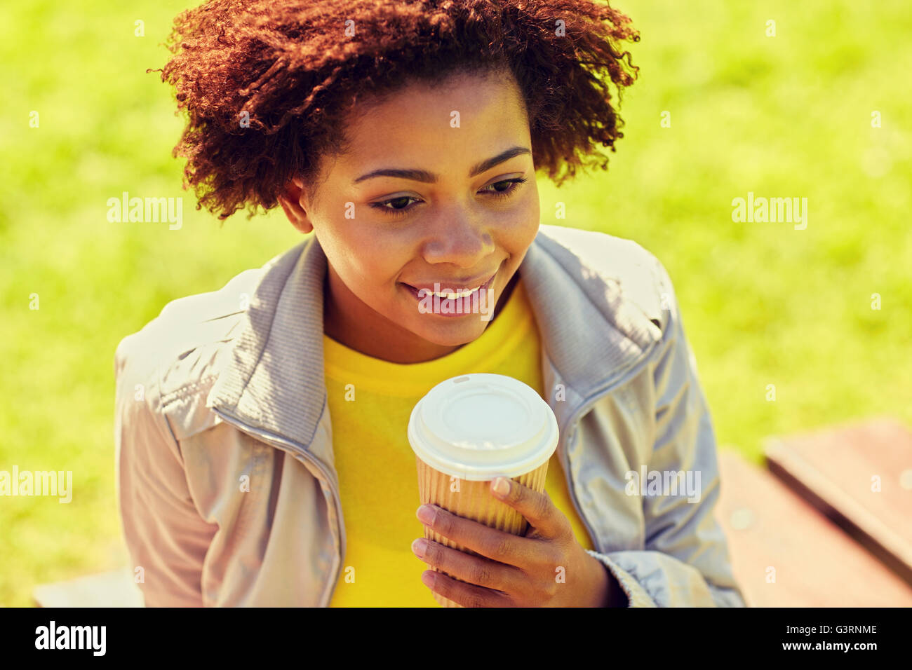 smiling african woman drinking coffee outdoors Stock Photo Alamy