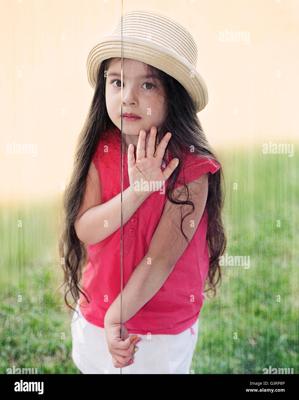 Portrait of a girl peeping through sliding glass door Stock Photo - Alamy