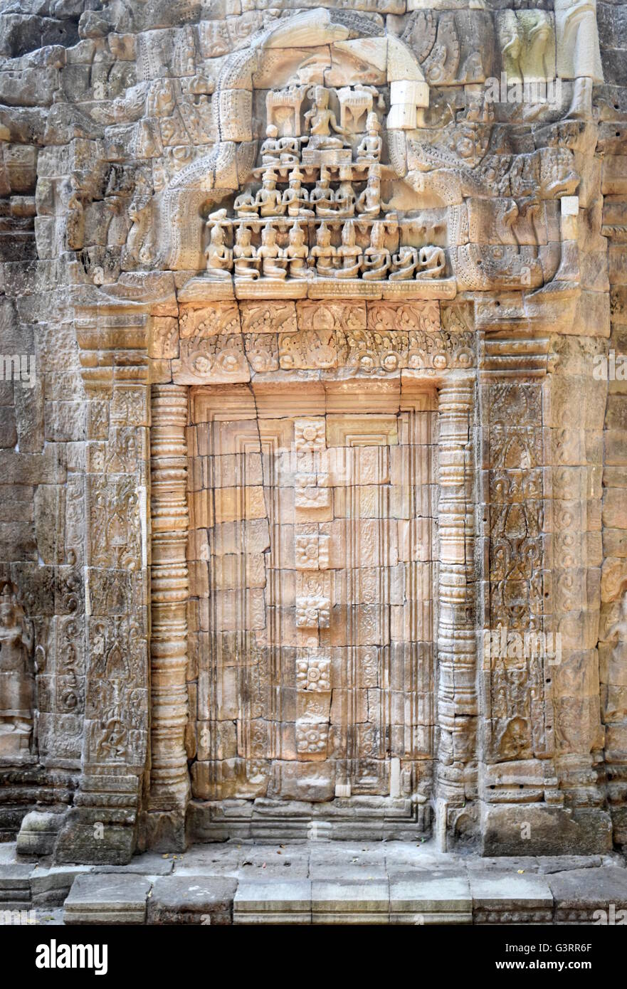 Stone gate - Entrance door carved on Ta Prohm ancient Buddhist temple - Cambodia Stock Photo