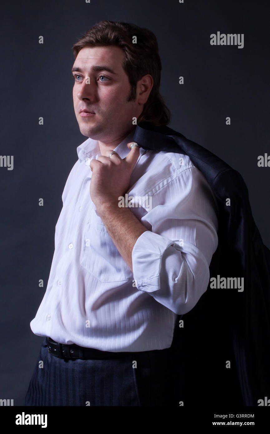portrait of a young man in a black suit with a gray background Stock ...