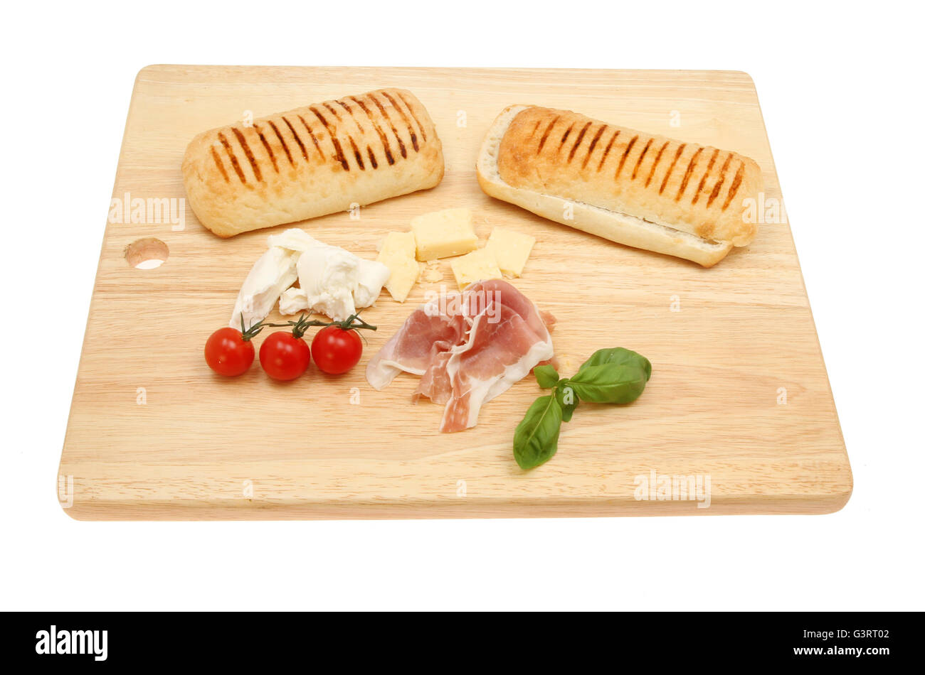 Pannini ingredients on a wooden chopping board isolated against white Stock Photo