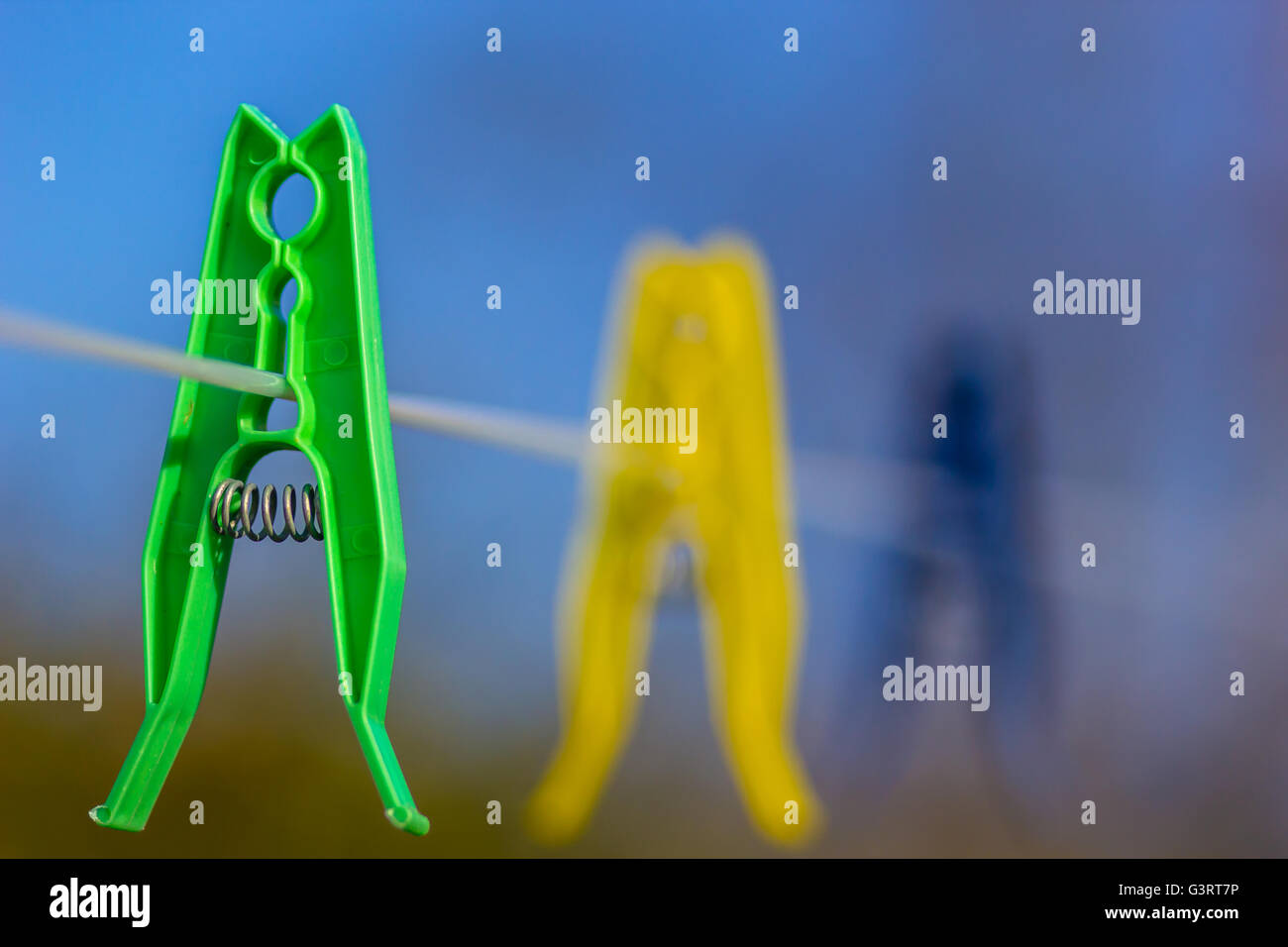 Colored clothes pegs on washing line Stock Photo