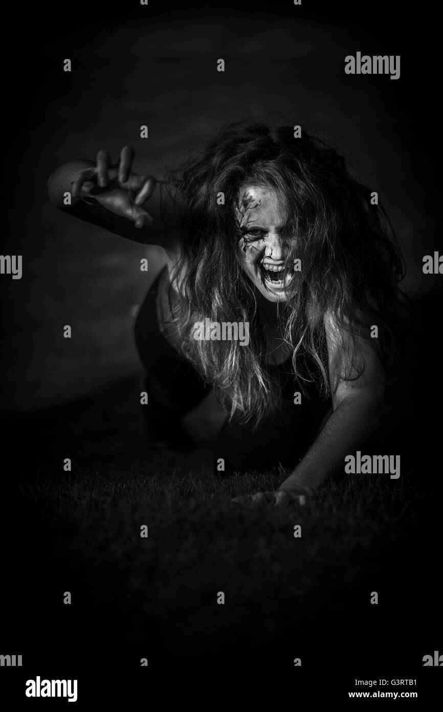 Terrifying blood-stained gruesome female zombie Stock Photo