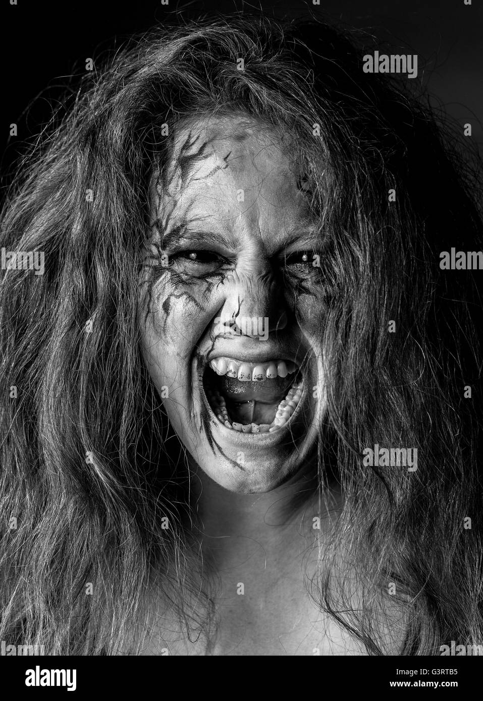 Terrifying blood-stained gruesome female zombie Stock Photo