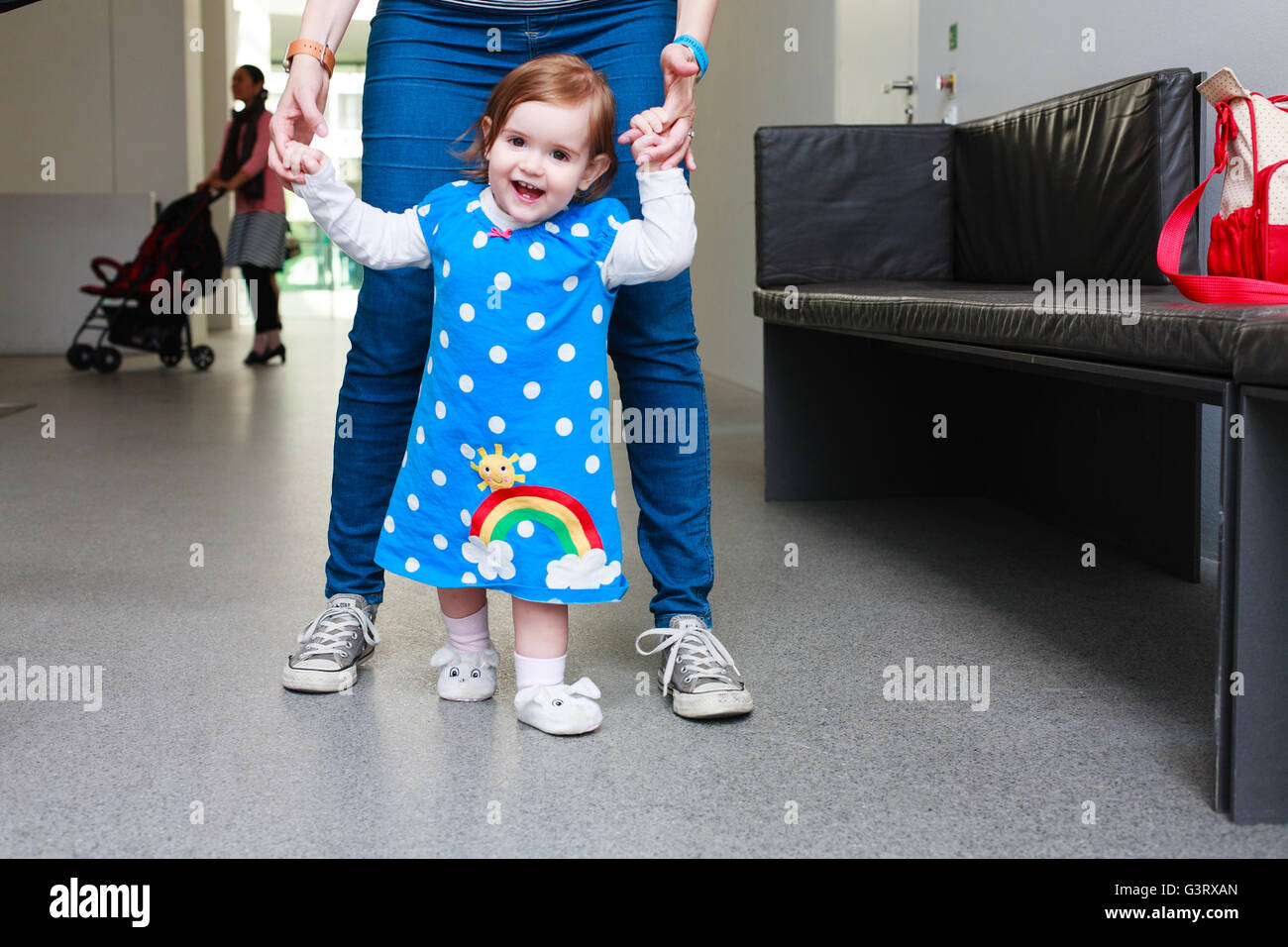 Toddler (girl) learning to walk Stock Photo