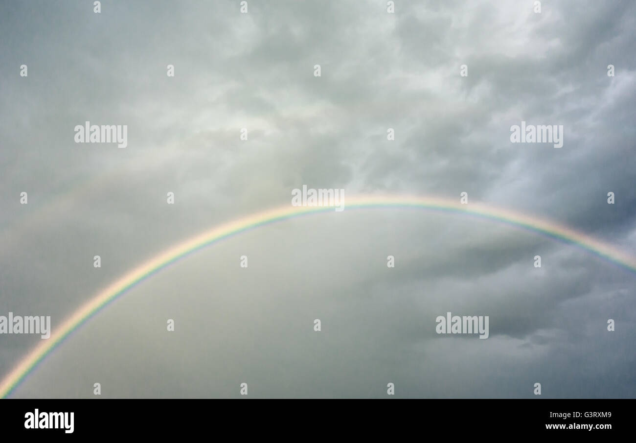 dark rainy sky with rainbow Stock Photo