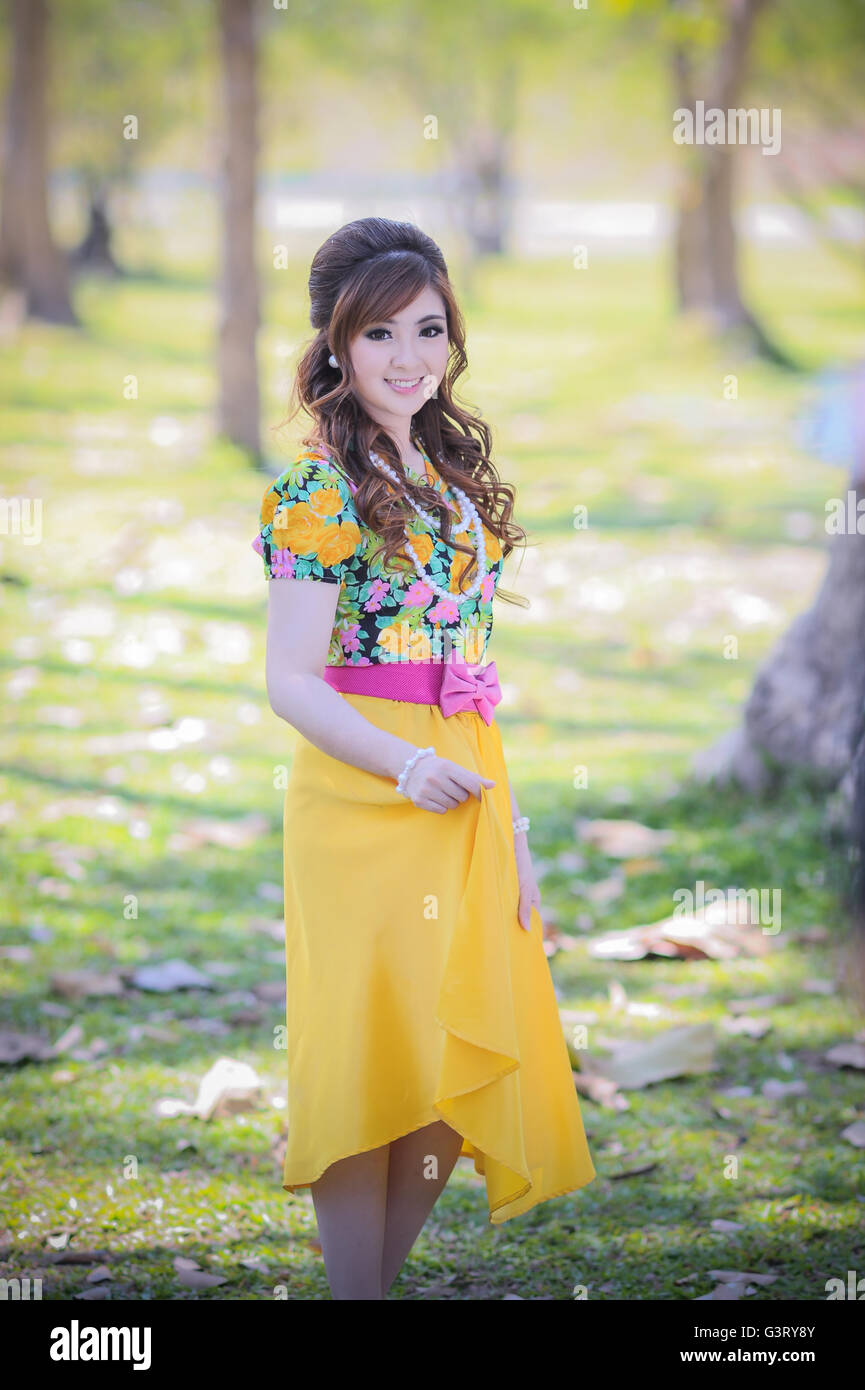 asia beautiful girl in the yellow dress on nature Stock Photo - Alamy
