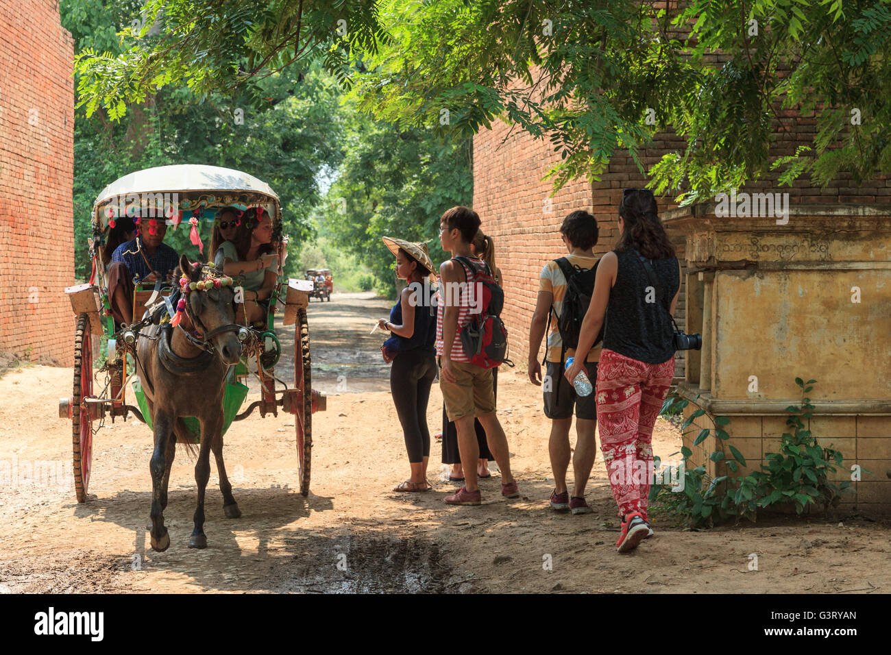 Tourists on horse carriage in Mandalay, Myanmar Stock Photo