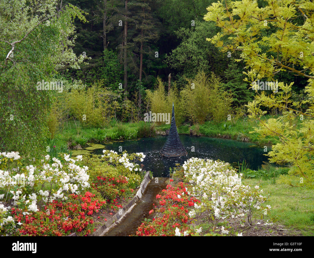 Sculpture Fountain in Pond at the Himalayan Garden & Sculpture Park, North Yorkshire, England UK. Stock Photo