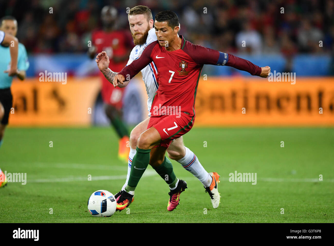 Saint-Etienne, France. 14th June, 2016. Cristiano Ronaldo (front) of Portugal and Aron Gunnarsson of Iceland vie for the ball during the UEFA Euro 2016 Group F soccer match Portugal vs. Iceland at Stade Geoffroy Guichard in Saint-Etienne, France, 14 June 2016. Photo: Uwe Anspach/dpa/Alamy Live News Stock Photo