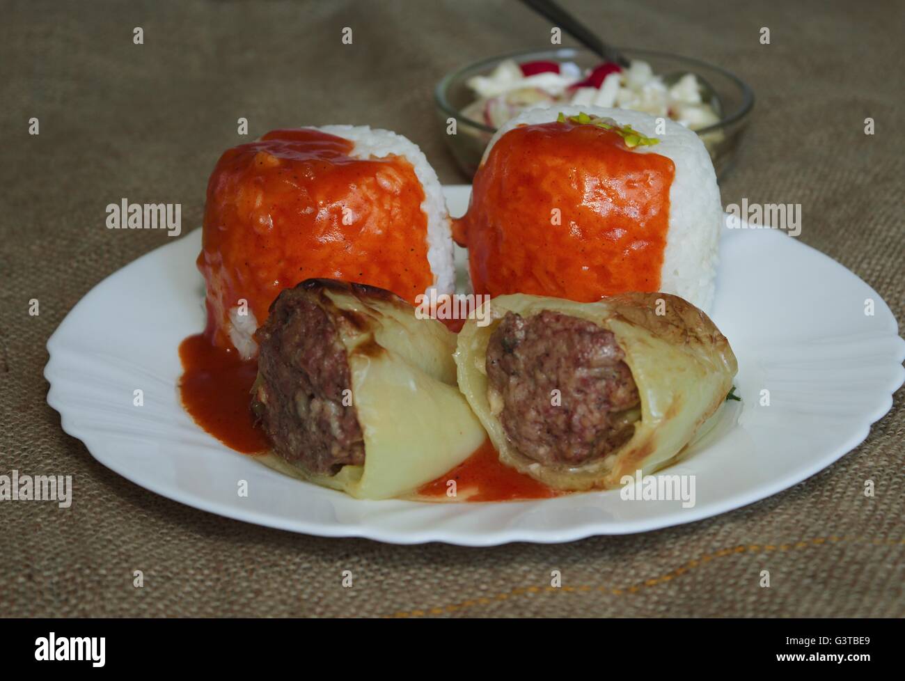 Spices onion stuffed sweet peppers with rice in tomato sauce hires
