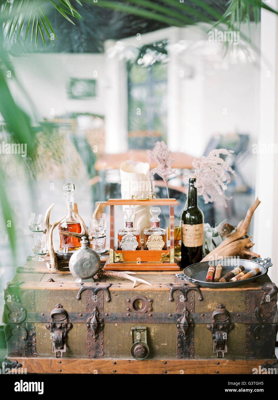 Sweden, Bottles with alcohol and tray with cigars on chest Stock Photo